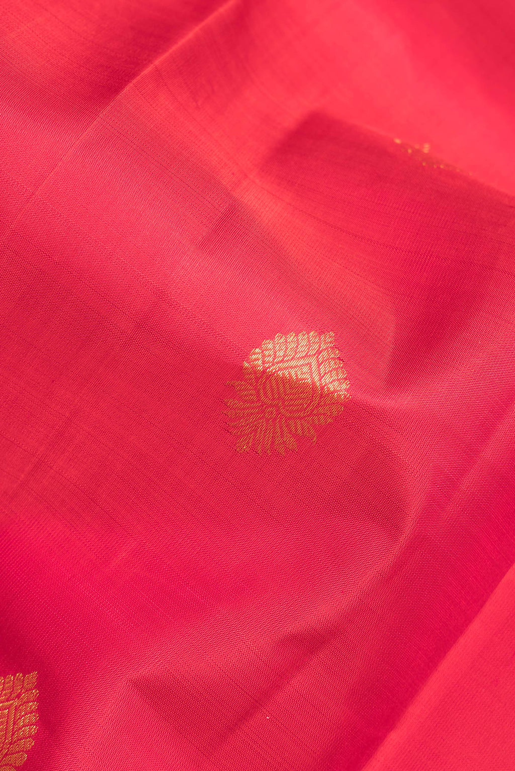 Close up of Pure Silk Red Kanchipuram Saree with Zari Butta on the body and Zari Border.  displaying folds