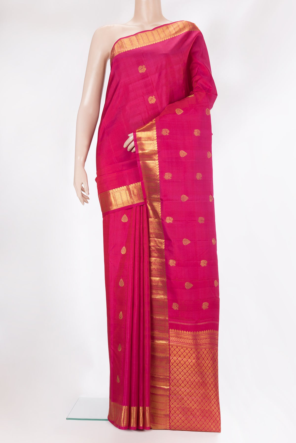 Pure Silk Dark Pink Kanjivaram Saree with Zari Butta on the body and Zari Border.  displayed on a mannequin