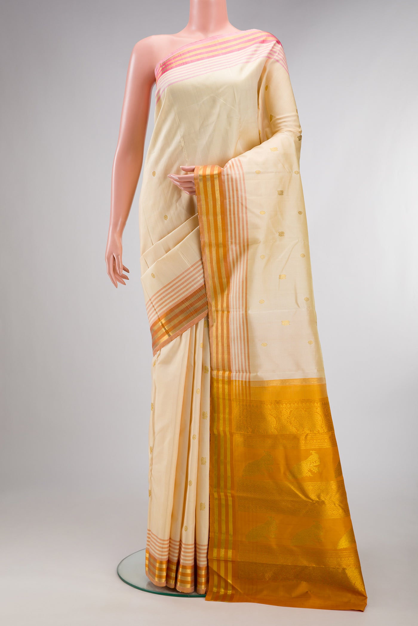 Pure Silk Sandal Kanjivaram Saree with Zari Butta on the body and Ganga Jamuna Border.  displayed on a mannequin