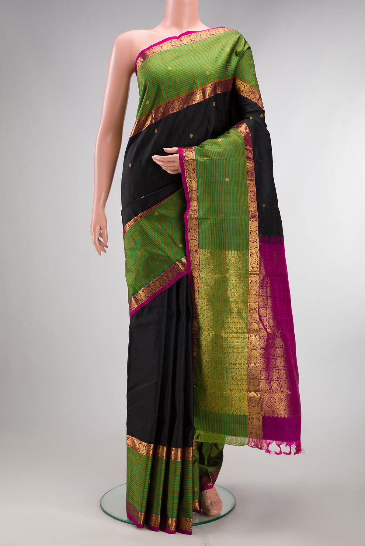 Pure Silk Black Kanjivaram Saree with Zari Butta on the body and Fancy Border.  displayed on a mannequin