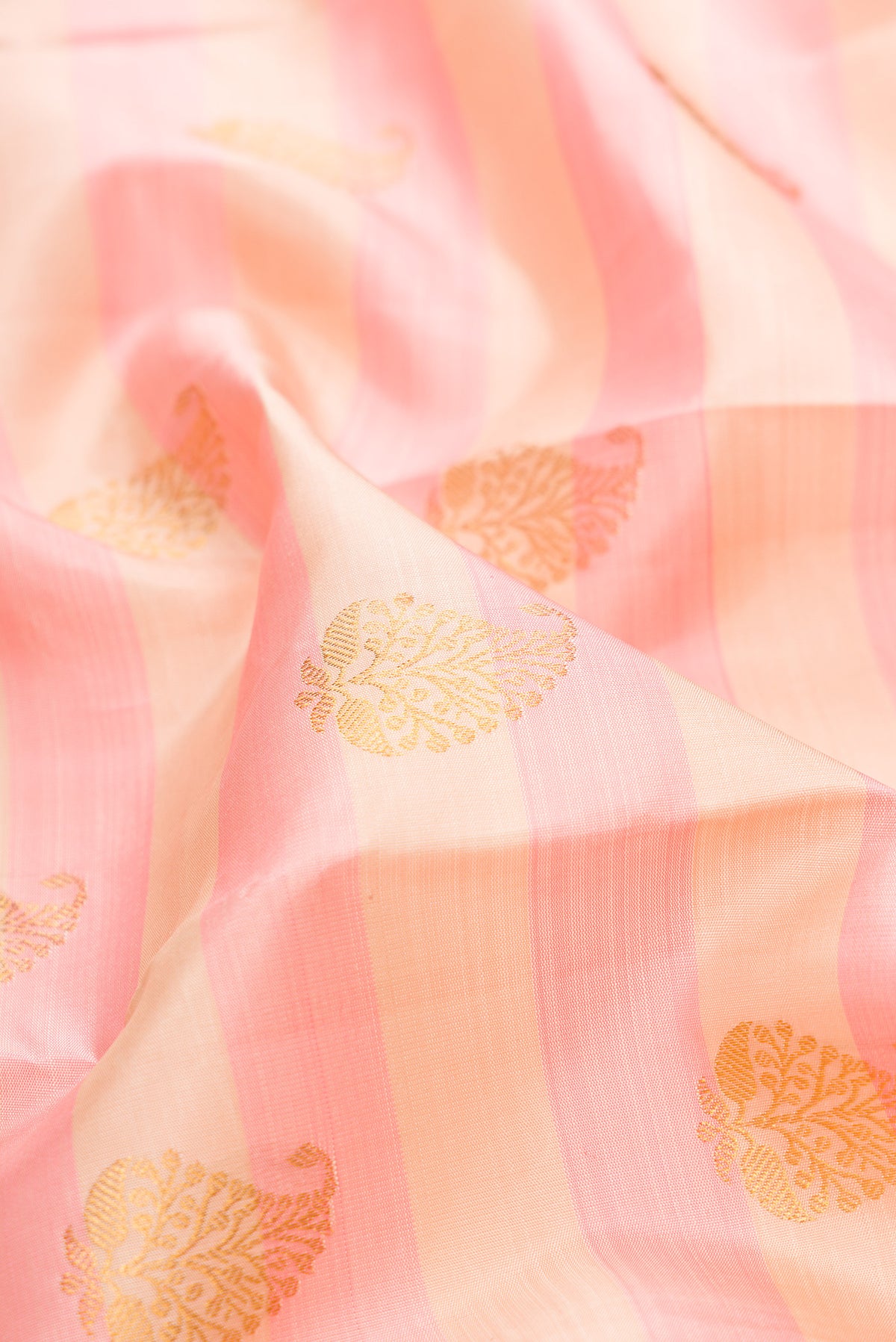 Close up of Pure Silk Pink and sandal Color Kanjivaram Saree with Stripes on the body and Zari Border.  displaying folds