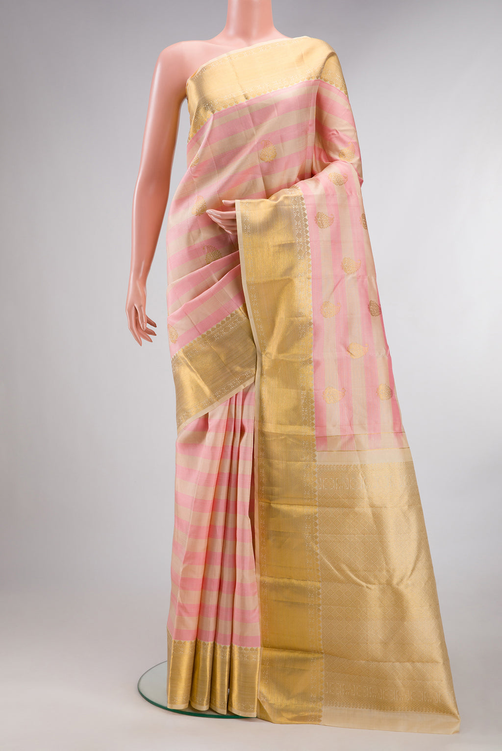 Pure Silk Pink and sandal Color Kanjivaram Saree with Stripes on the body and Zari Border.  displayed on a mannequin