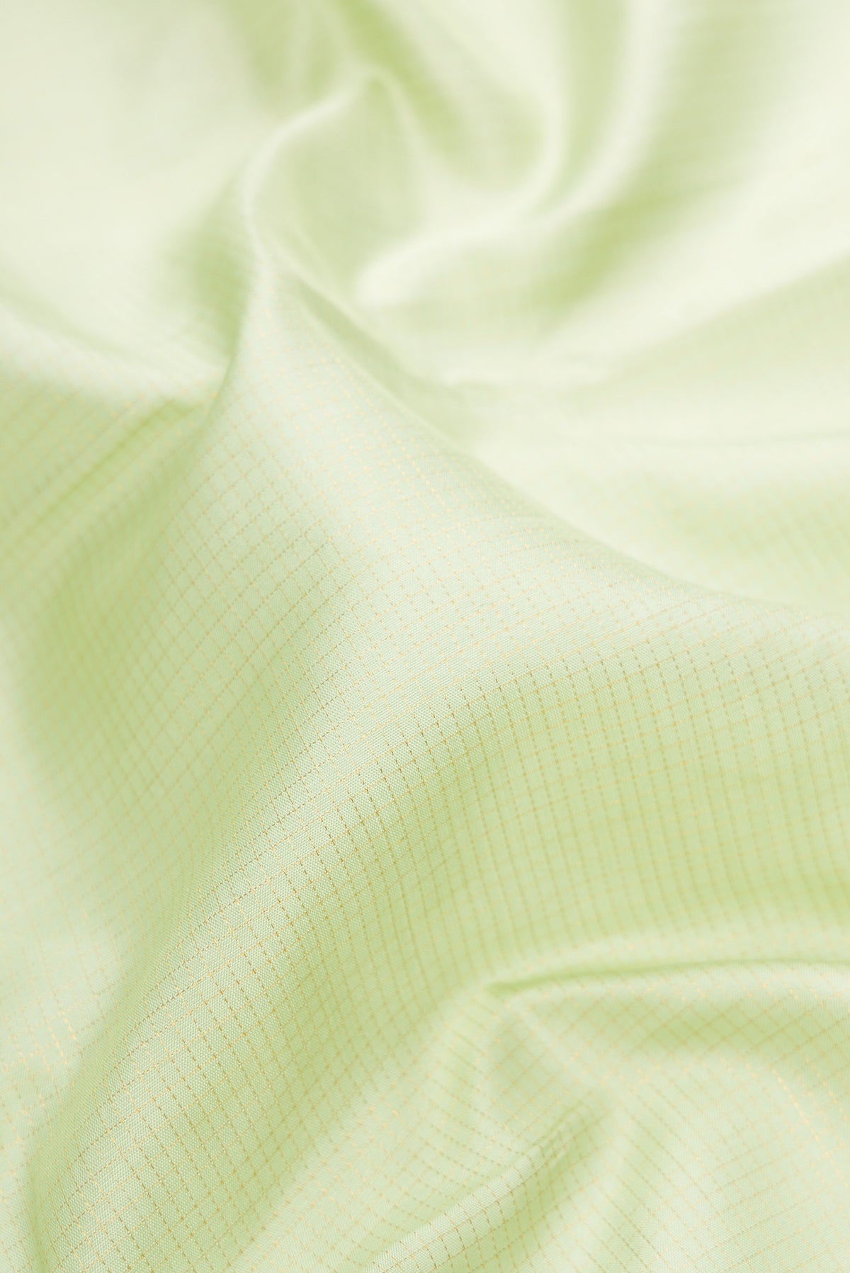 Close up of Pure Silk Pista Green Kanjivaram Saree with Checked design on the body and Zari Border.  displaying folds