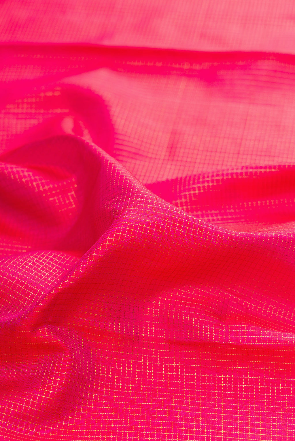 Close up of Pure Silk Pink Kanjivaram Saree with Checked design on the body and Zari Border.  displaying folds