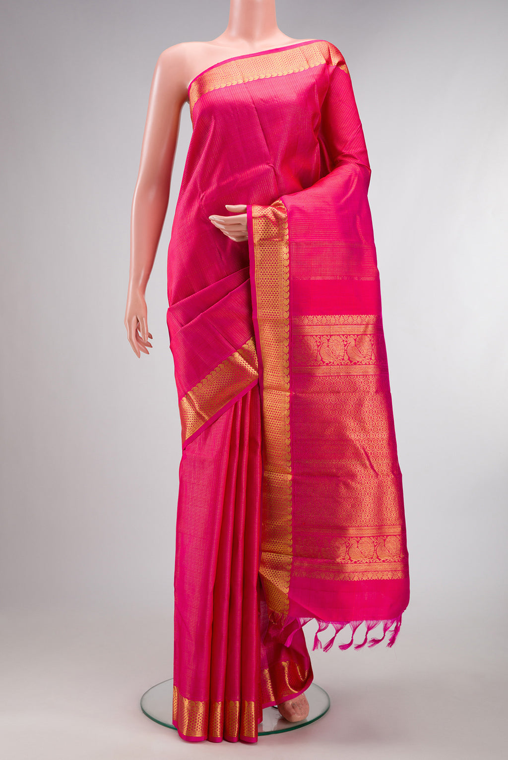 Pure Silk Pink Kanjivaram Saree with Checked design on the body and Zari Border.  displayed on a mannequin