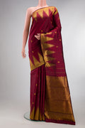 Pure Silk Maroon Kanjivaram Saree with Zari Butta on the body and Temple Border.  displayed on a mannequin