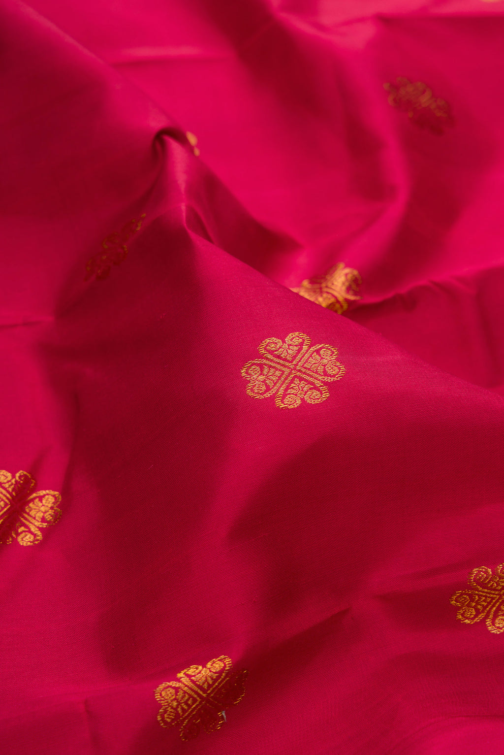 Close up of Pure Silk Maroon Kanjivaram Saree with Zari Butta on the body and Fancy Border.  displaying folds