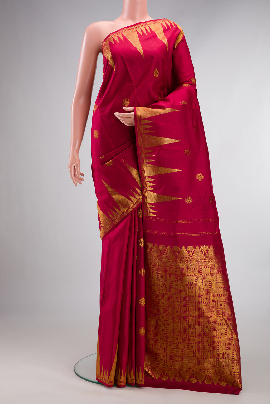 Pure Silk Maroon Kanjivaram Saree with Zari Butta on the body and Fancy Border.  displayed on a mannequin