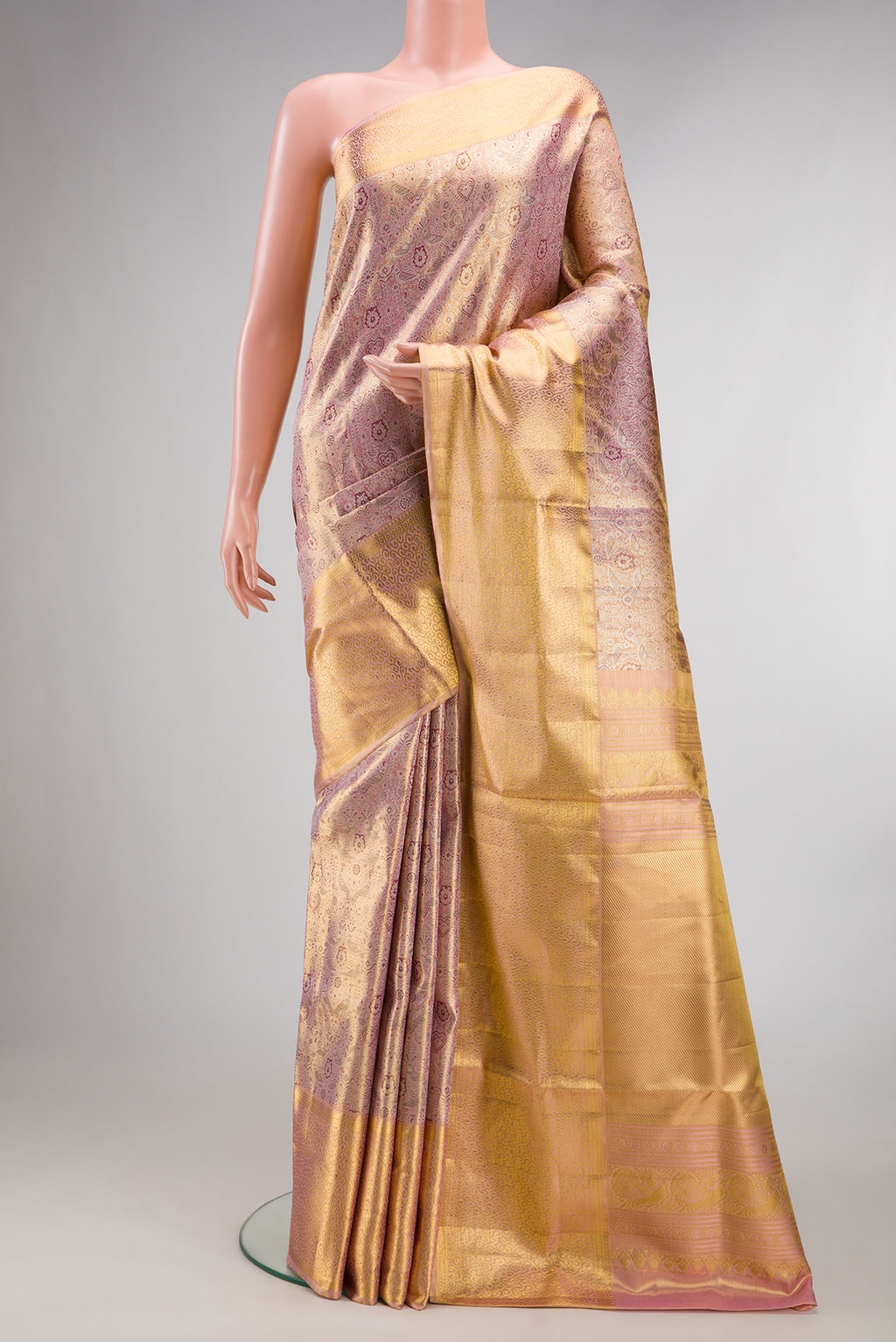 Rose Gold Dual Tone Kanjivaram Tissue Saree with Zari Brocade on the body and Zari Border.  displayed on a mannequin