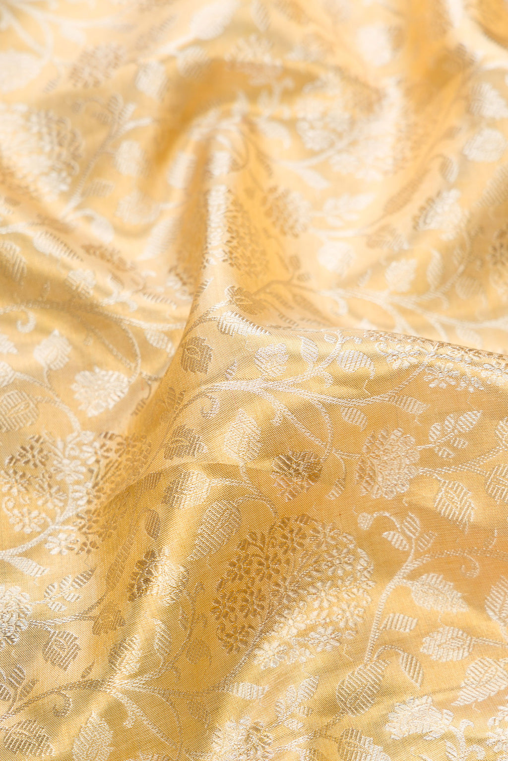 Close up of Pure Silk Gold Dual Tone Kanchipuram Tissue Saree with Zari Brocade on the body and Fancy Border.  displaying folds