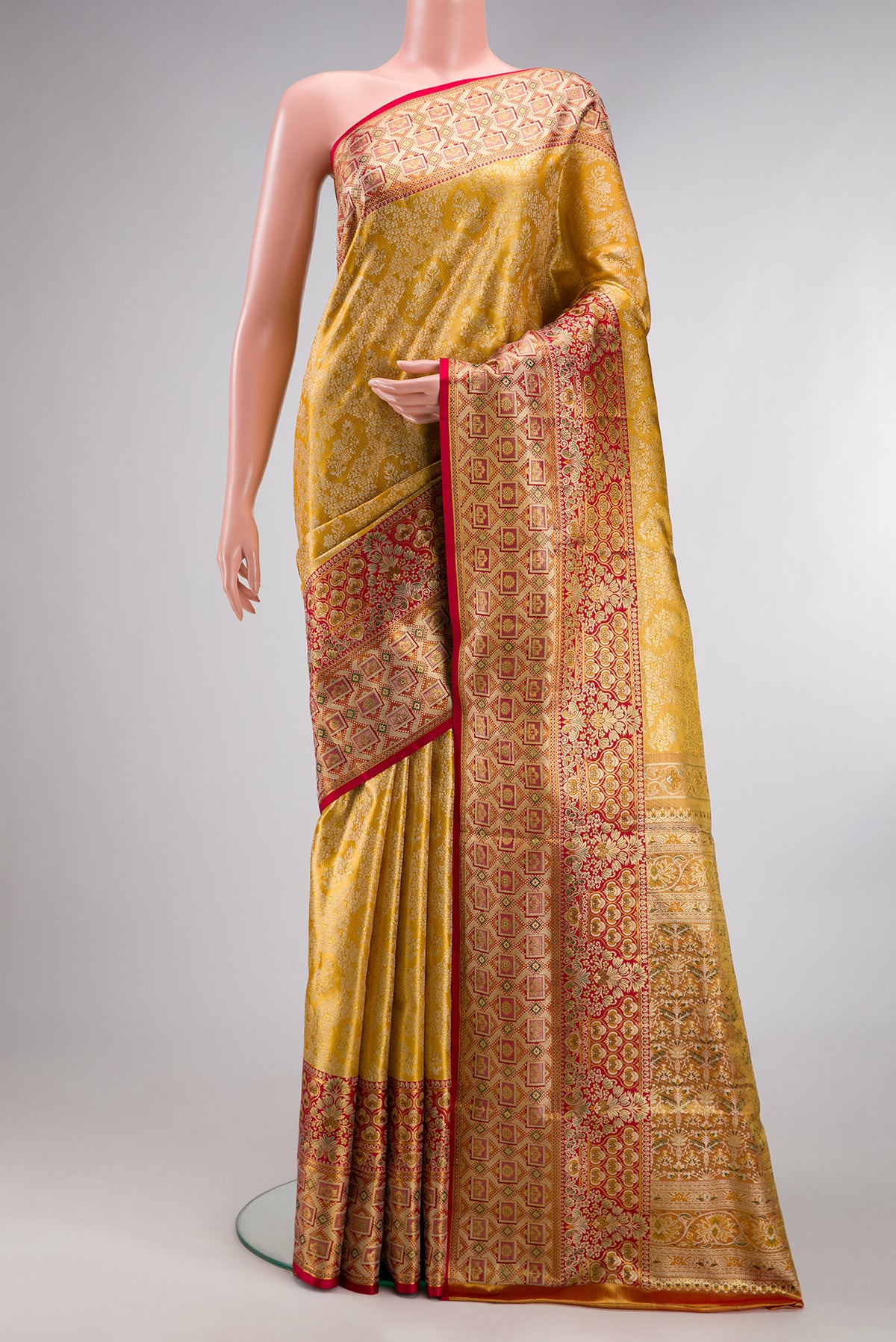 Pure Silk Gold Dual Tone Kanchipuram Tissue Saree with Zari Brocade on the body and Fancy Border.  displayed on a mannequin