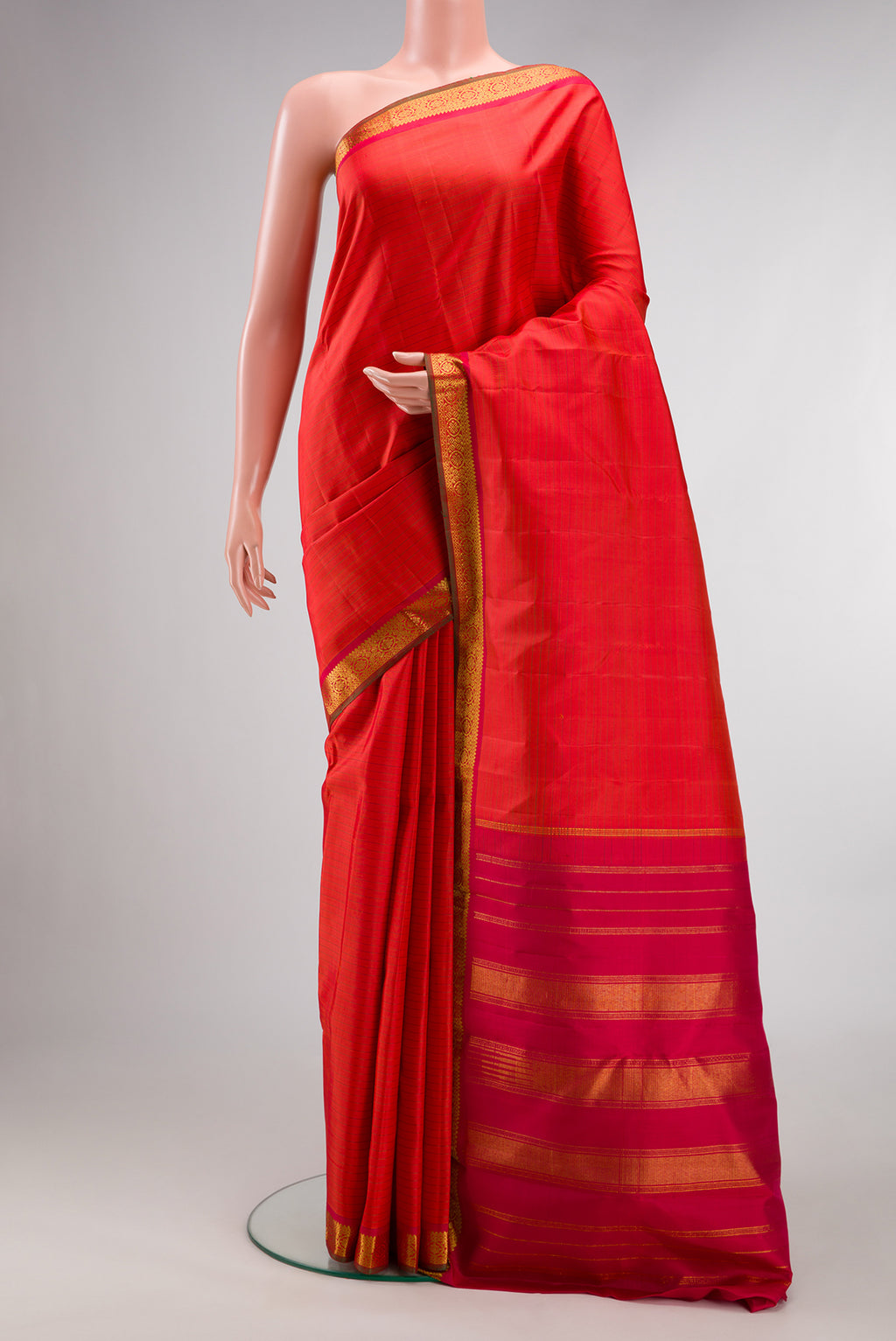 Pure Silk Brick Orange Dual Tone Kanchipuram Saree with Stripes on the body and Zari Border.  displayed on a mannequin
