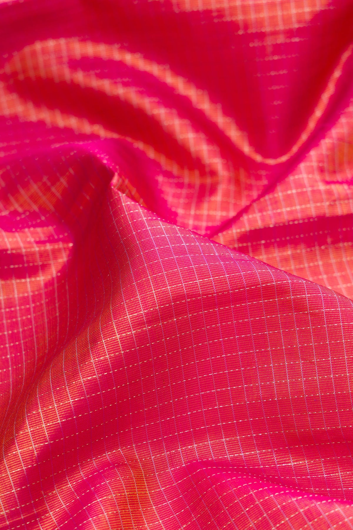 Close up of Pure Silk Pink Kanjivaram Saree with Checked design on the body and Zari Border.  displaying folds