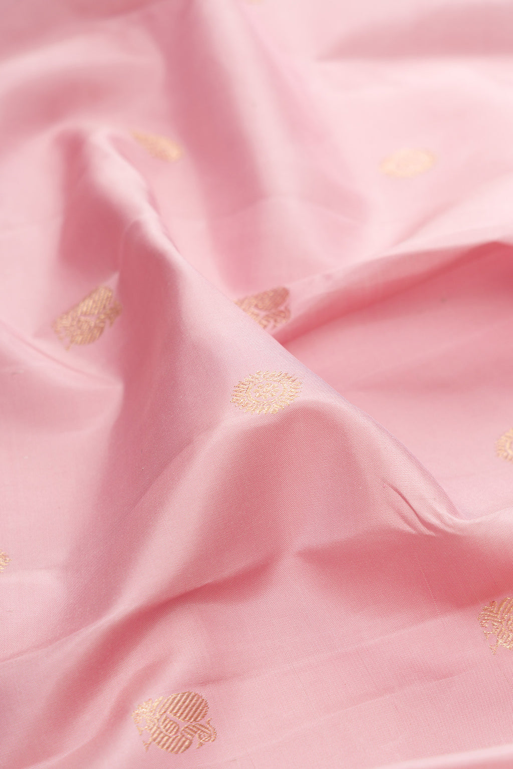 Close up of Pure Silk Pink Kanjivaram Saree with Zari Butta on the body and Checks Border.  displaying folds