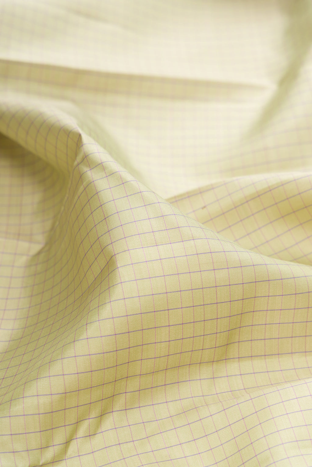 Close up of Pure Silk Pista Green Kanchipuram Saree with Checked design on the body and Plain Border.  displaying folds