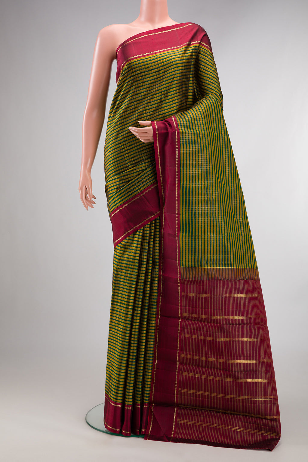 Pure Silk Bottle Green Kanjivaram Saree with Checked design on the body and Zari Border.  displayed on a mannequin