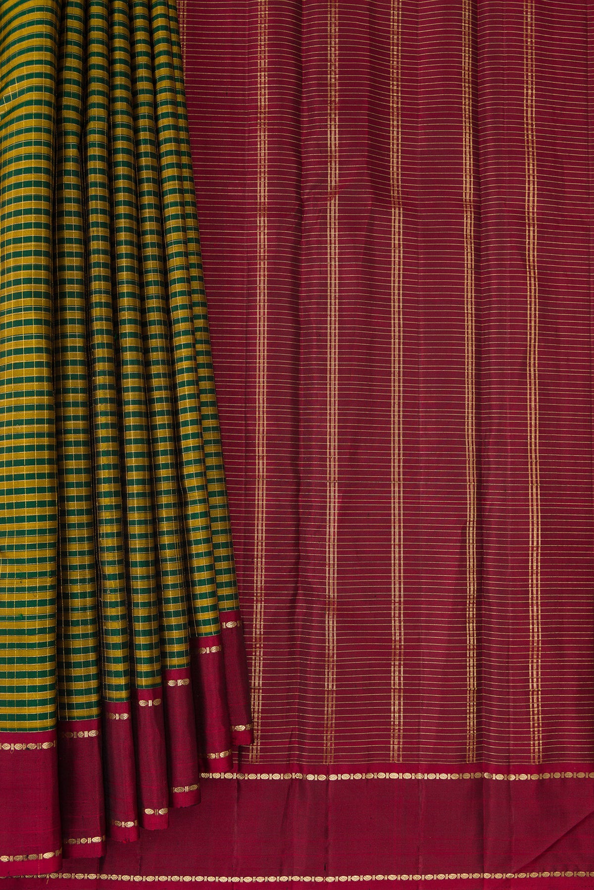 Pleats and pallu of Pure Silk Bottle Green Kanjivaram Saree with Checked design on the body and Zari Border. 