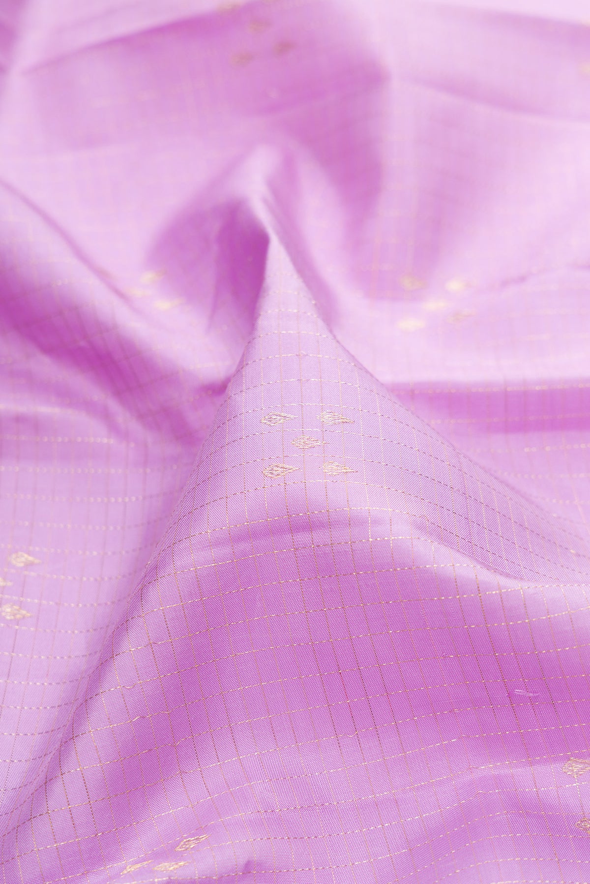Close up of Pure Silk Lavender Kanjivaram Saree with Zari Butta on the body and Without Border.  displaying folds