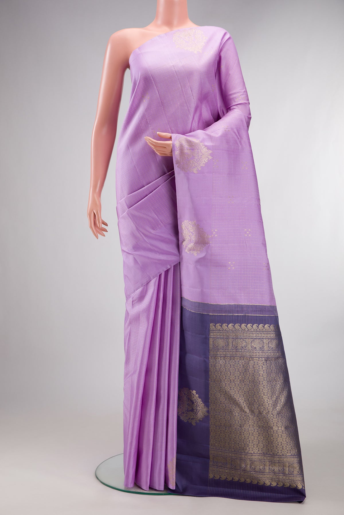 Pure Silk Lavender Kanjivaram Saree with Zari Butta on the body and Without Border.  displayed on a mannequin