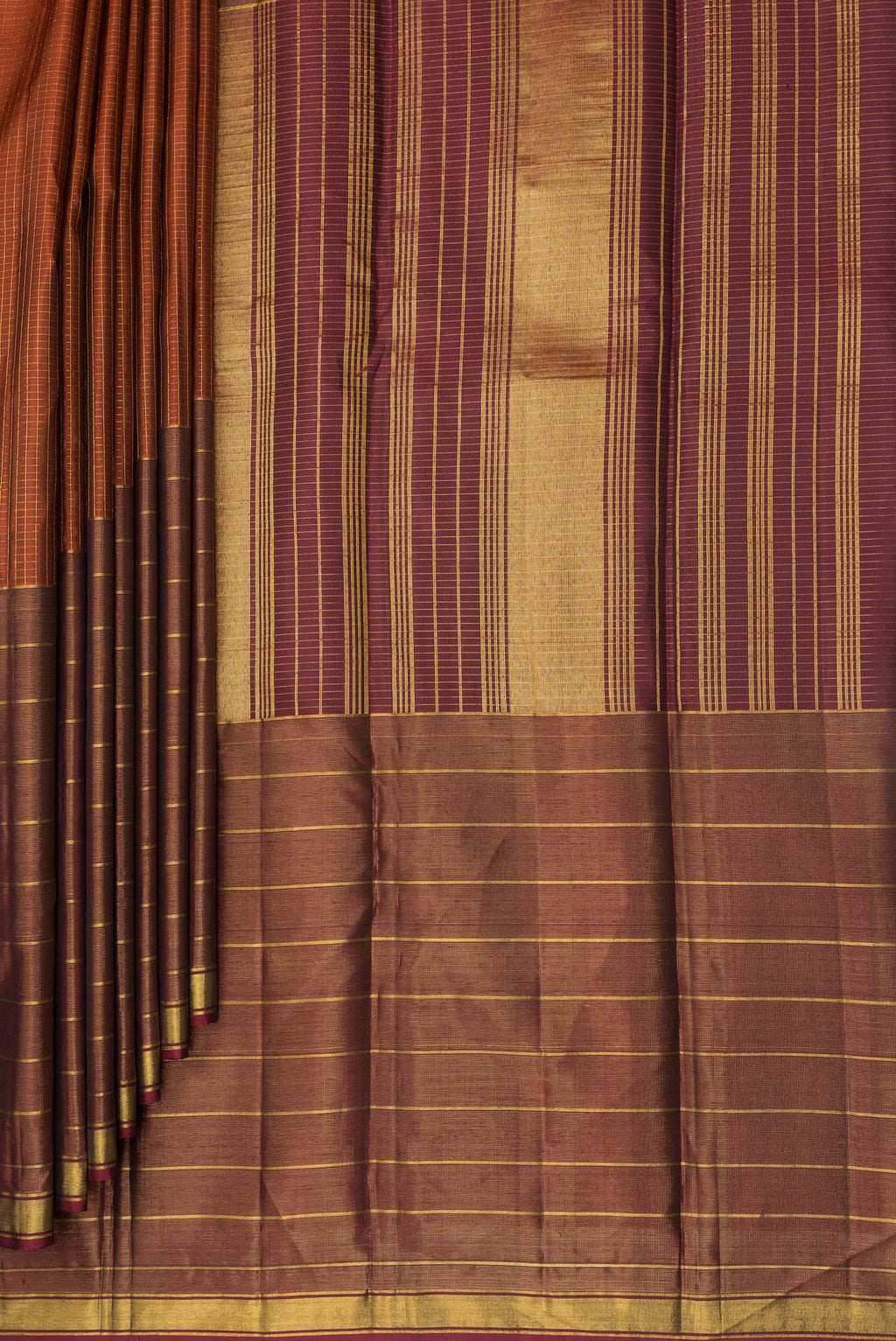 Pleats and pallu of Pure Silk Rust Kanjivaram Saree with Checked design on the body and Ganga Jamuna Border. 