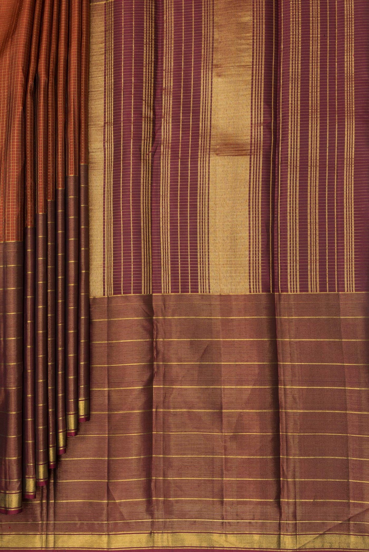 Pleats and pallu of Pure Silk Rust Kanjivaram Saree with Checked design on the body and Ganga Jamuna Border. 