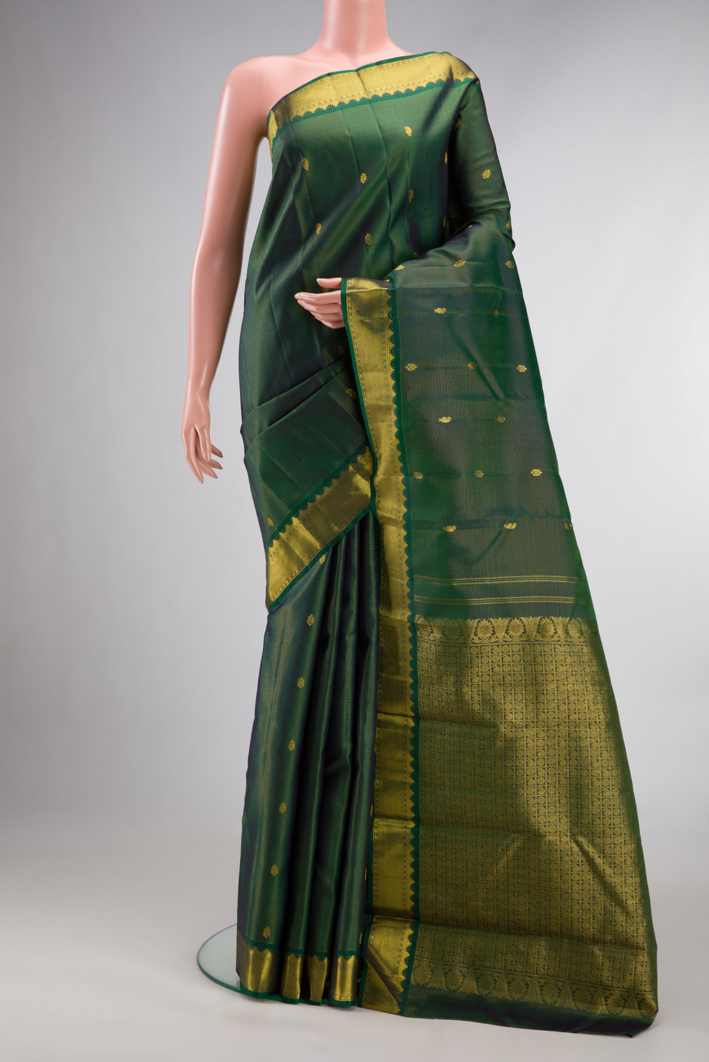 Pure Silk Bottle Green Kanjivaram Saree with Zari Butta on the body and Zari Border.  displayed on a mannequin