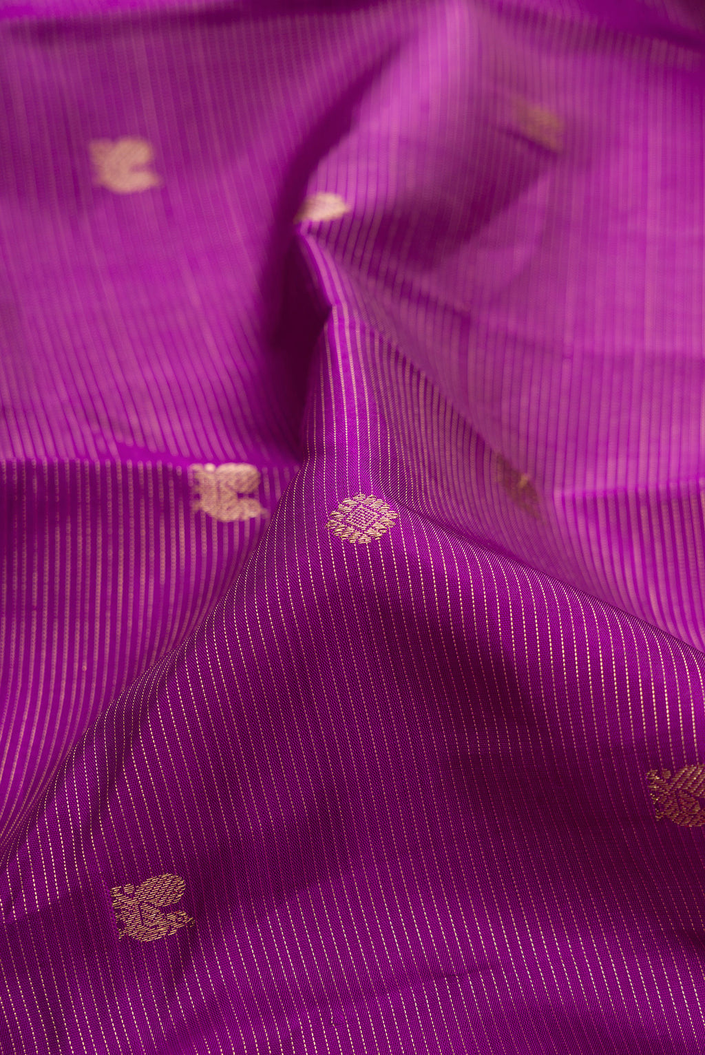 Close up of Pure Silk Purple Kanjivaram Saree with Stripes on the body and Zari Border.  displaying folds