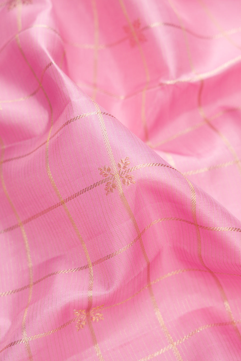 Close up of Pure Silk Pink Kanjivaram Saree with Checked design on the body and Fancy Border.  displaying folds