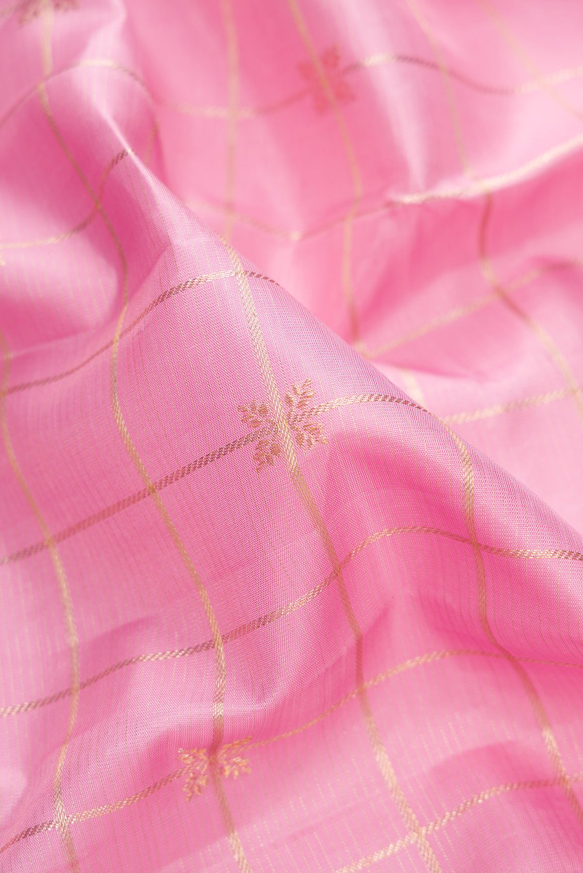 Close up of Pure Silk Pink Kanjivaram Saree with Checked design on the body and Fancy Border.  displaying folds