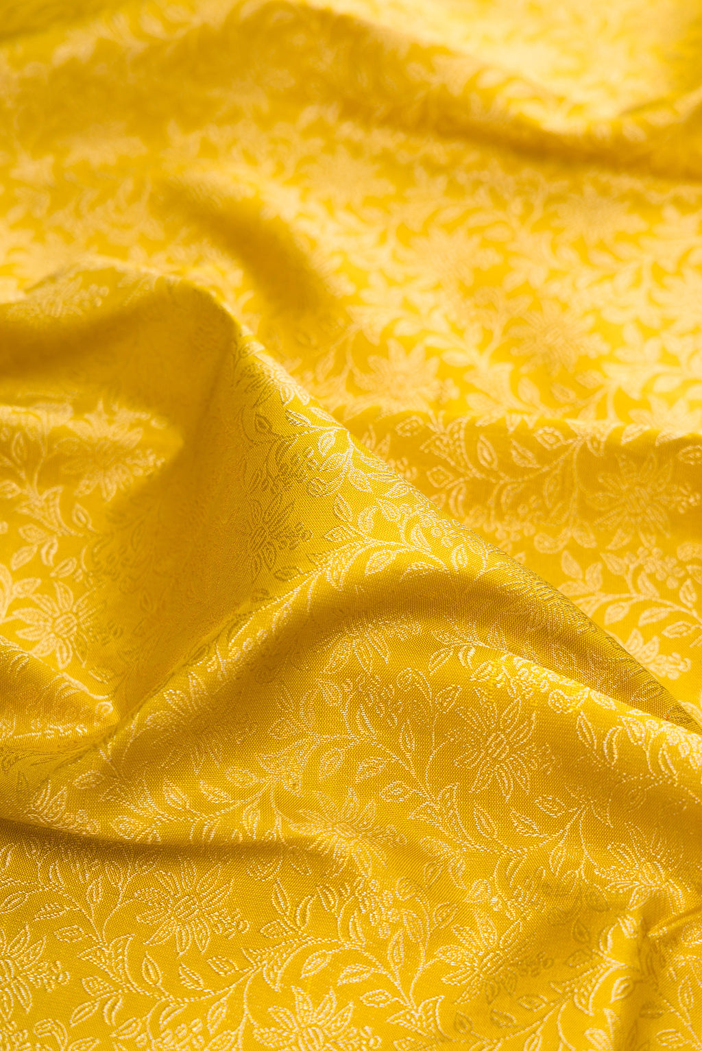 Close up of Pure Silk Gold Dual Tone Kanchipuram Saree with Zari Brocade on the body and Fancy Border.  displaying folds