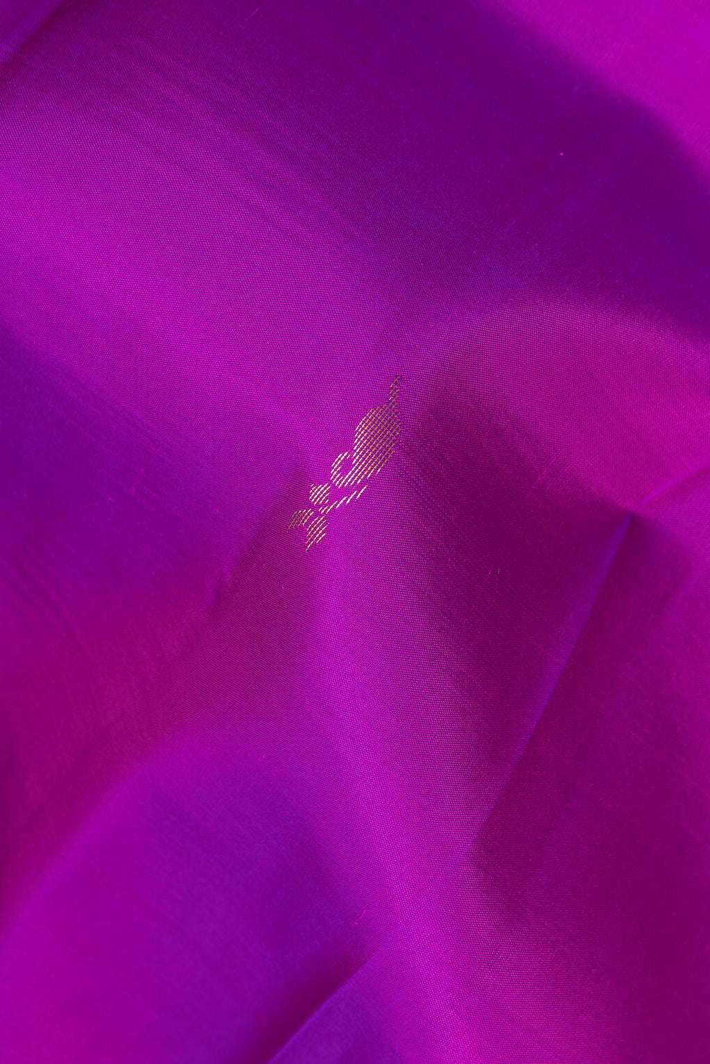 Close up of Pure Silk Purple Kanchipuram Saree with Zari Butta on the body and Fancy Border.  displaying folds
