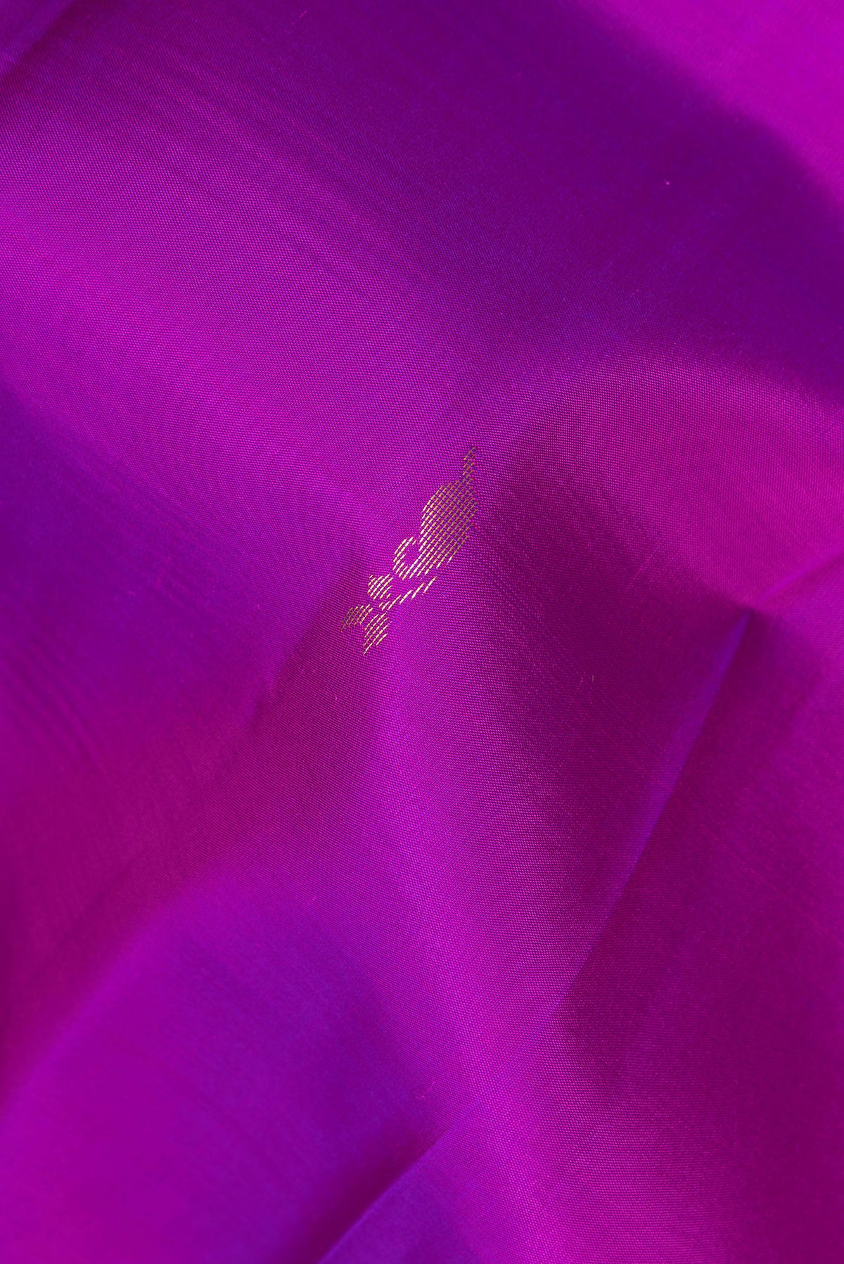 Close up of Pure Silk Purple Kanchipuram Saree with Zari Butta on the body and Fancy Border.  displaying folds