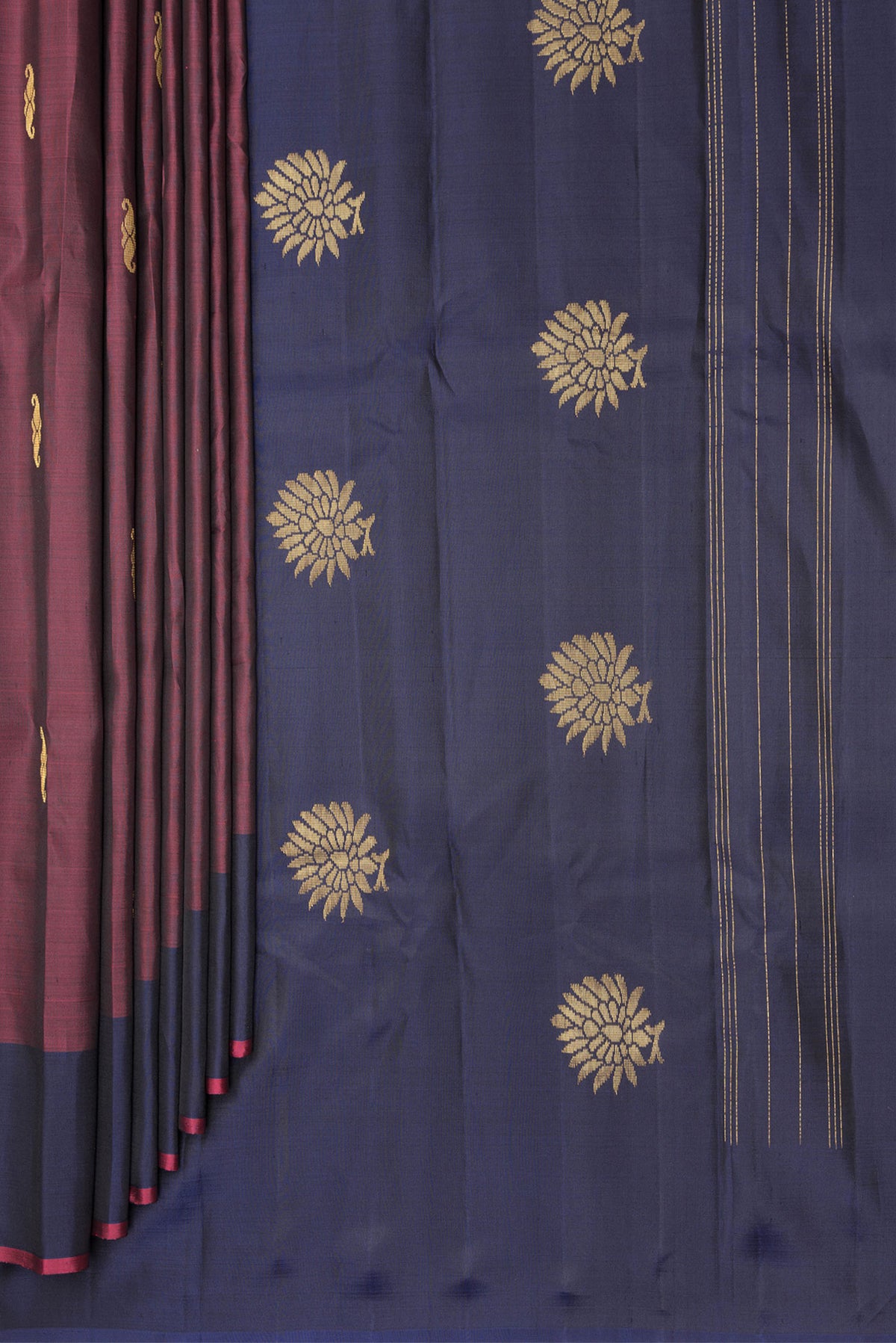 Pleats and pallu of Pure Silk Maroon Dual Tone Kanchipuram Saree with Zari Butta on the body and Fancy Border. 