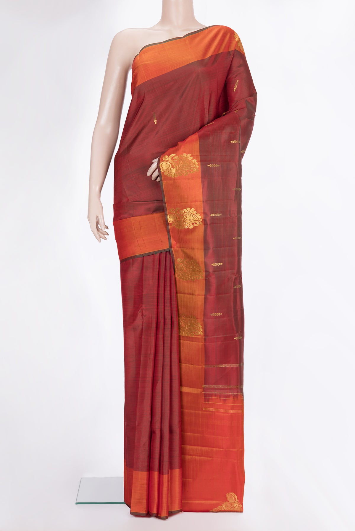 Pure Silk Rust Dual Tone Kanchipuram Saree with Zari Butta on the body and Fancy Border.  displayed on a mannequin
