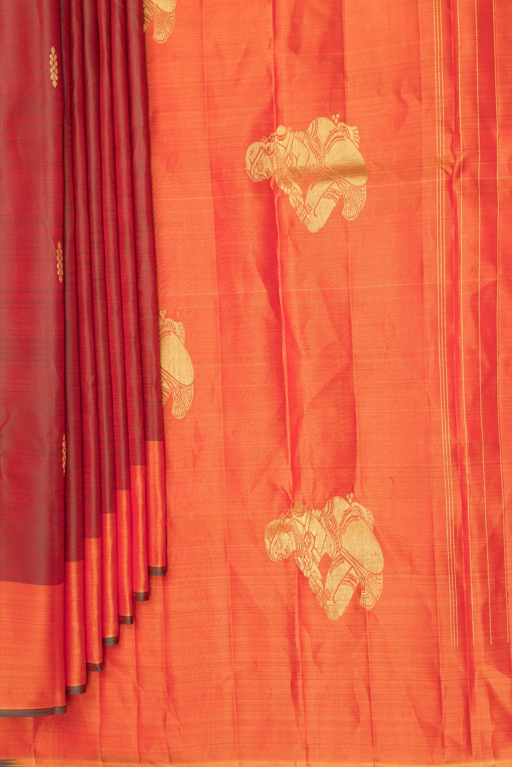 Pleats and pallu of Pure Silk Rust Dual Tone Kanchipuram Saree with Zari Butta on the body and Fancy Border. 