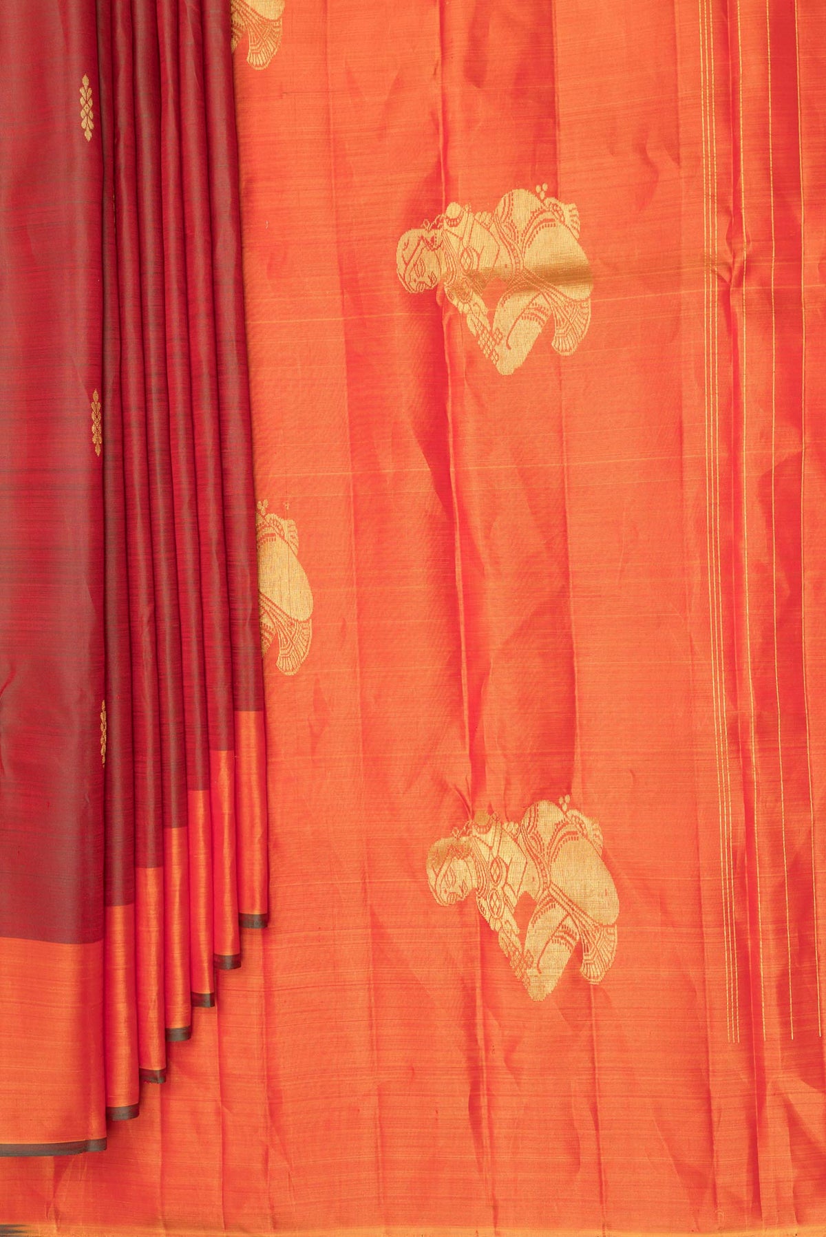 Pleats and pallu of Pure Silk Rust Dual Tone Kanchipuram Saree with Zari Butta on the body and Fancy Border. 