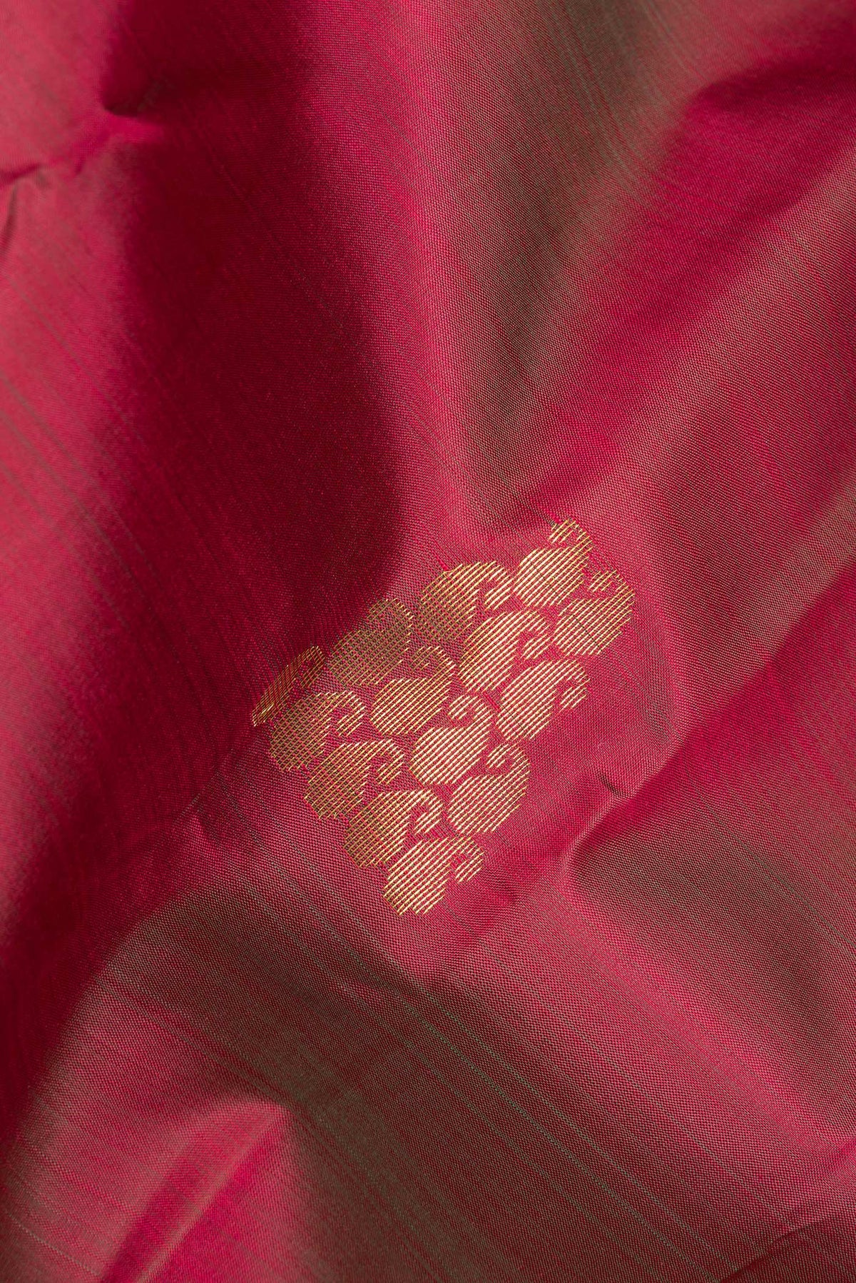 Close up of Pure Silk Maroon Kanchipuram Saree with Zari Butta on the body and Fancy Border.  displaying folds
