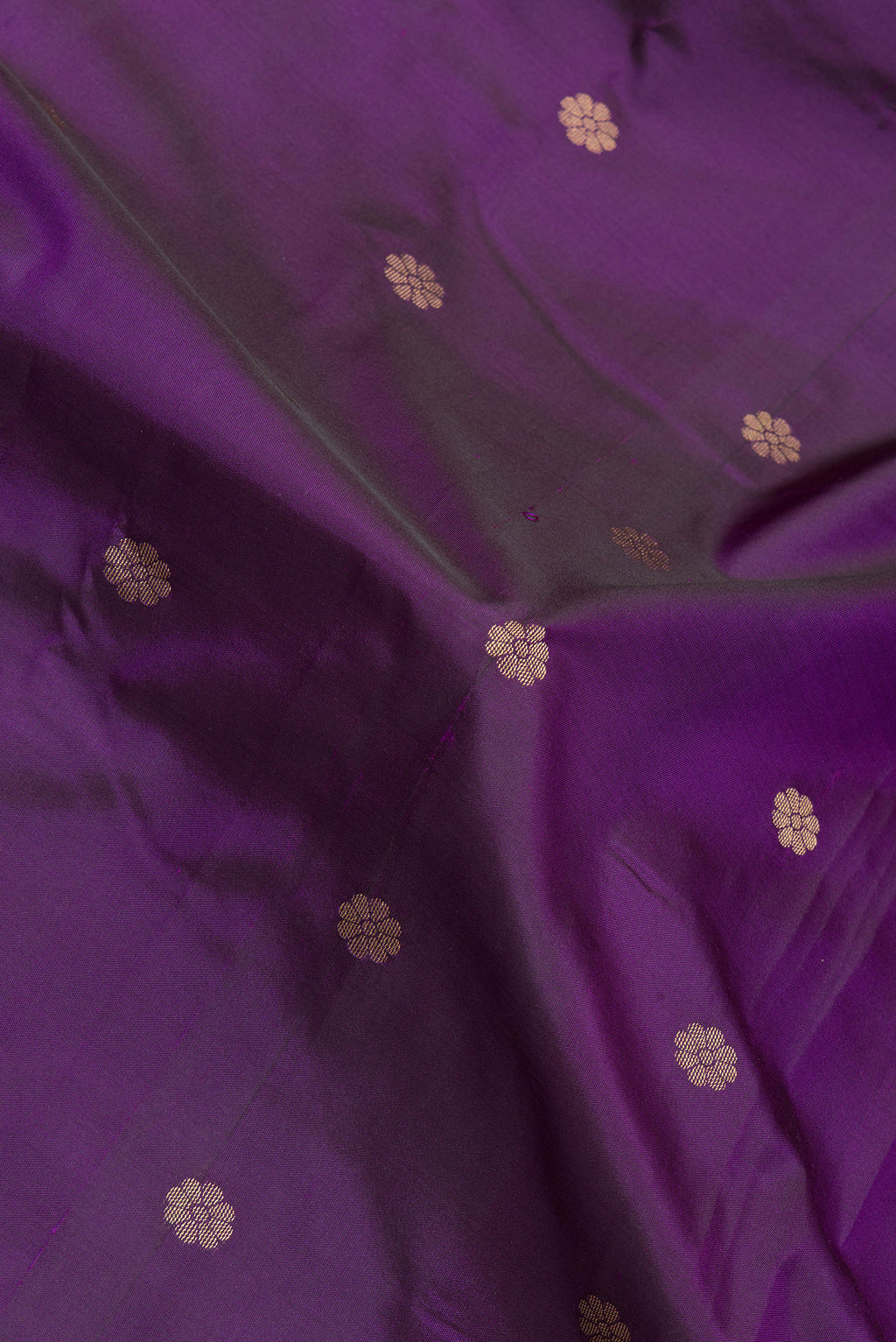 Close up of Purple Blended Paithani Silk Saree with Zari Butta on the body and Zari Border.  displaying folds