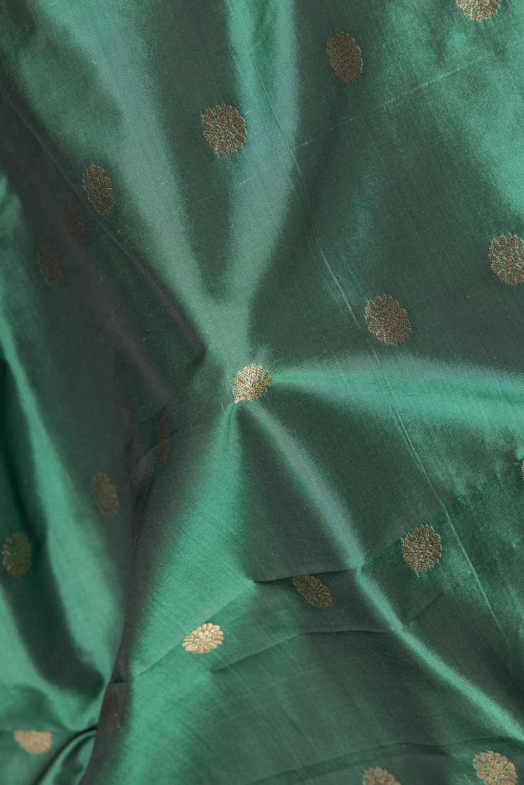 Close up of Green Blended Paithani Silk Saree with Zari Butta on the body and Zari Border.  displaying folds