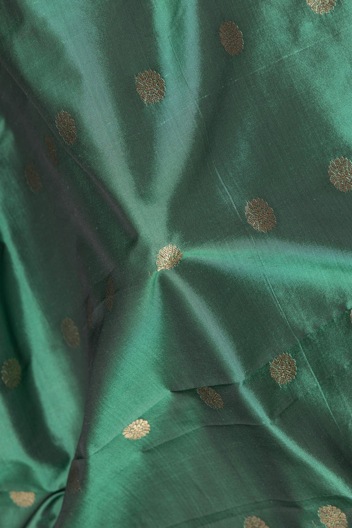 Close up of Green Blended Paithani Silk Saree with Zari Butta on the body and Zari Border.  displaying folds