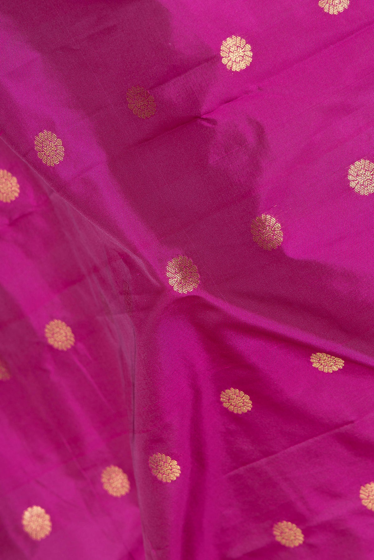 Close up of Magenta Blended Paithani Silk Saree with Zari Butta on the body and Zari Border.  displaying folds
