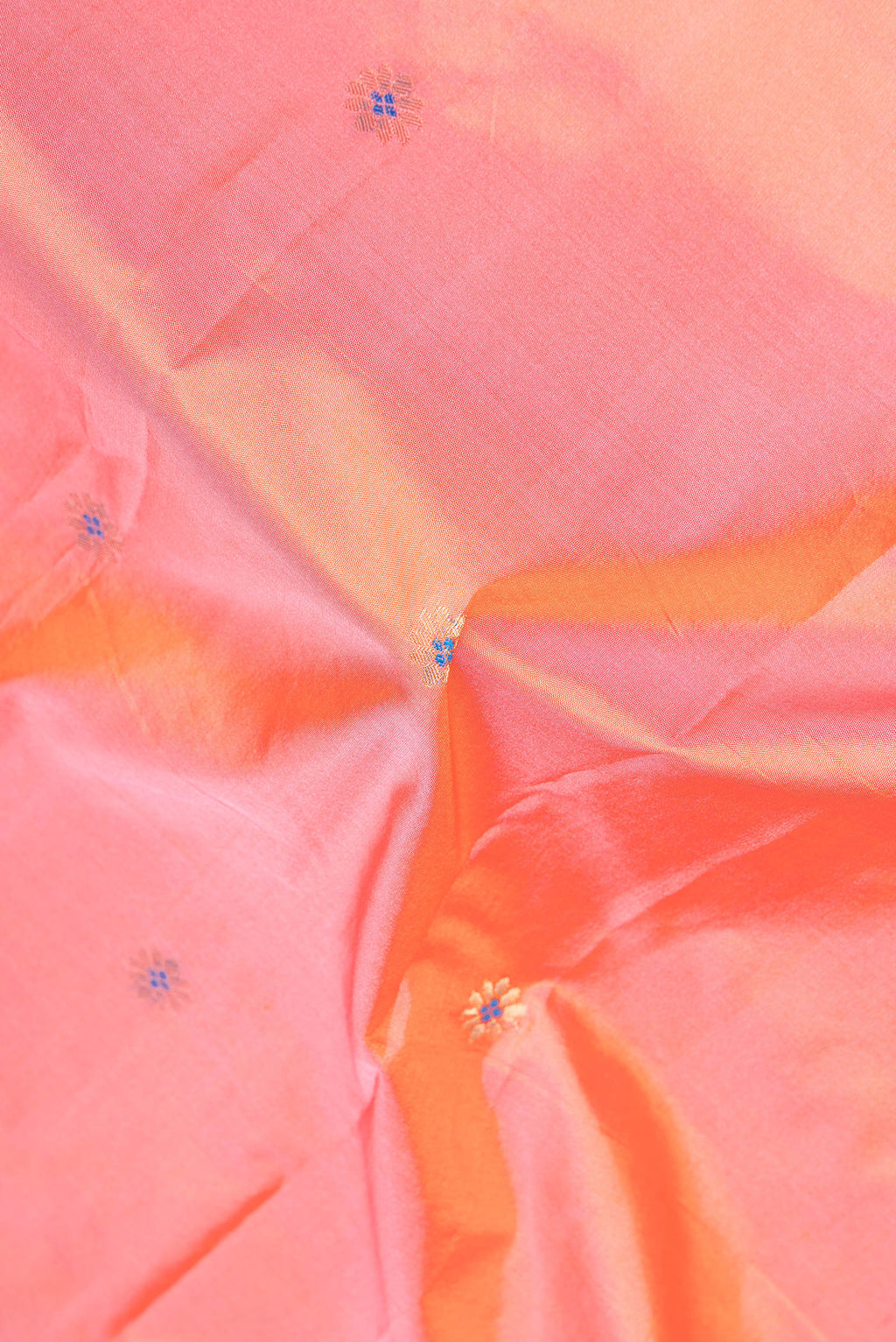 Close up of Peach Dual Tone Blended Paithani Silk Saree with Zari Butta on the body and Zari Border.  displaying folds