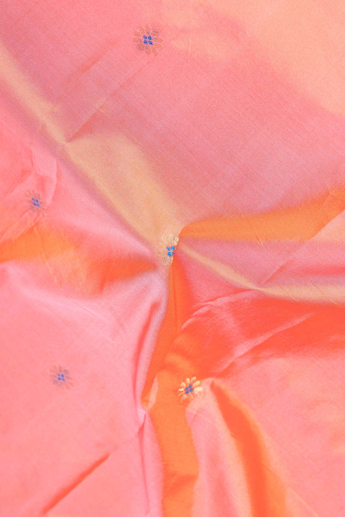 Close up of Peach Dual Tone Blended Paithani Silk Saree with Zari Butta on the body and Zari Border.  displaying folds