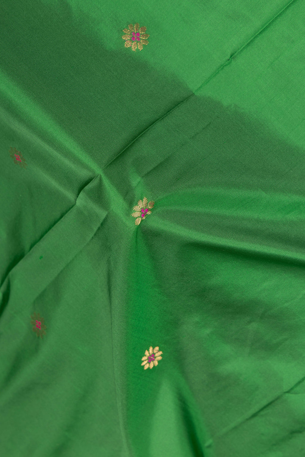 Close up of Green Blended Paithani Silk Saree with Zari Butta on the body and Zari Border.  displaying folds