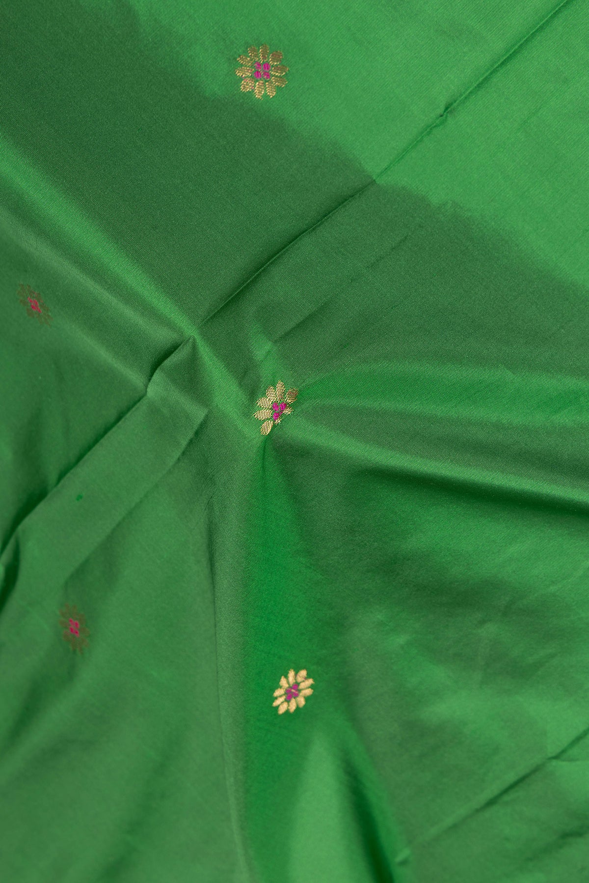 Close up of Green Blended Paithani Silk Saree with Zari Butta on the body and Zari Border.  displaying folds