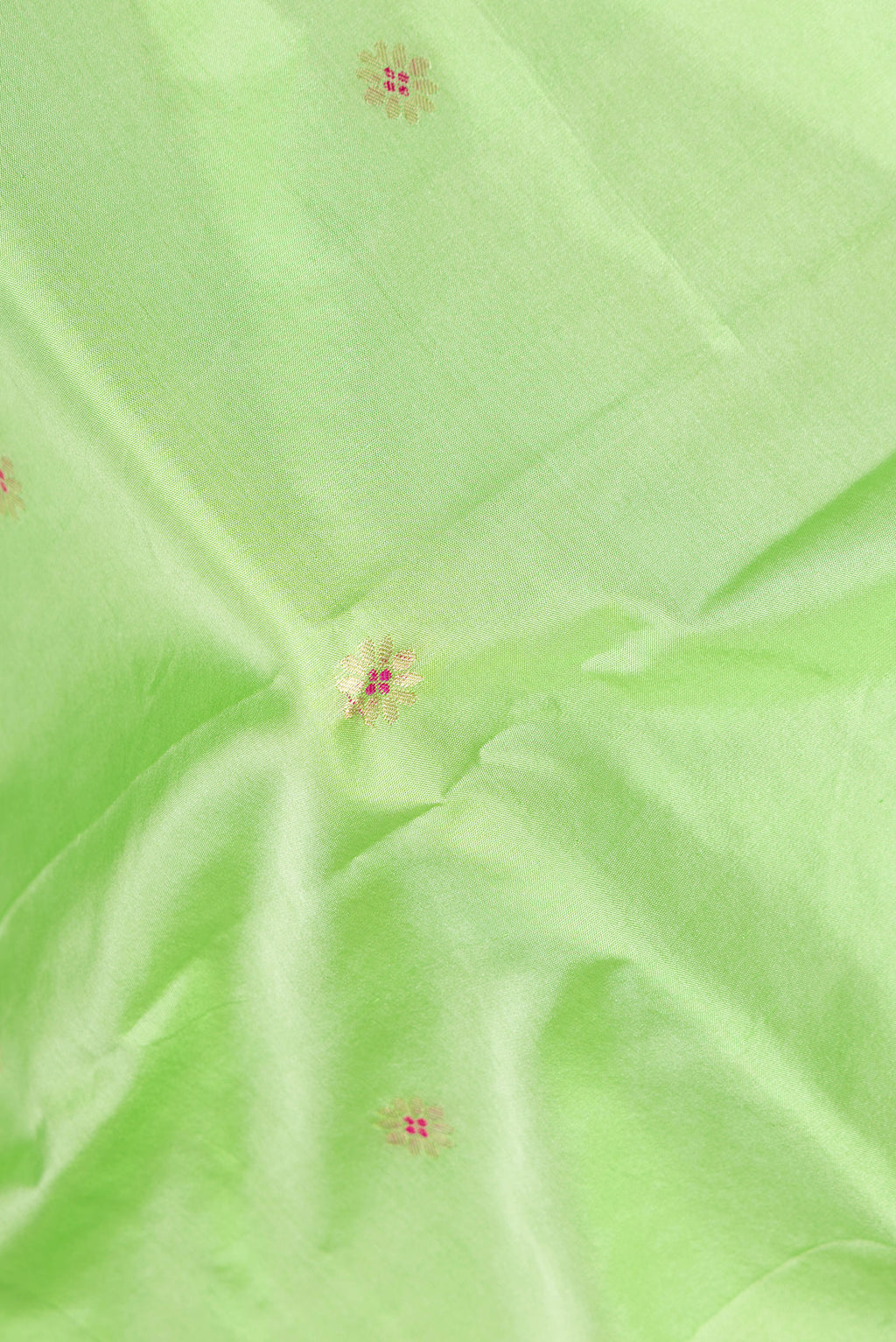 Close up of Pista Green Blended Paithani Silk Saree with Zari Butta on the body and Zari Border.  displaying folds