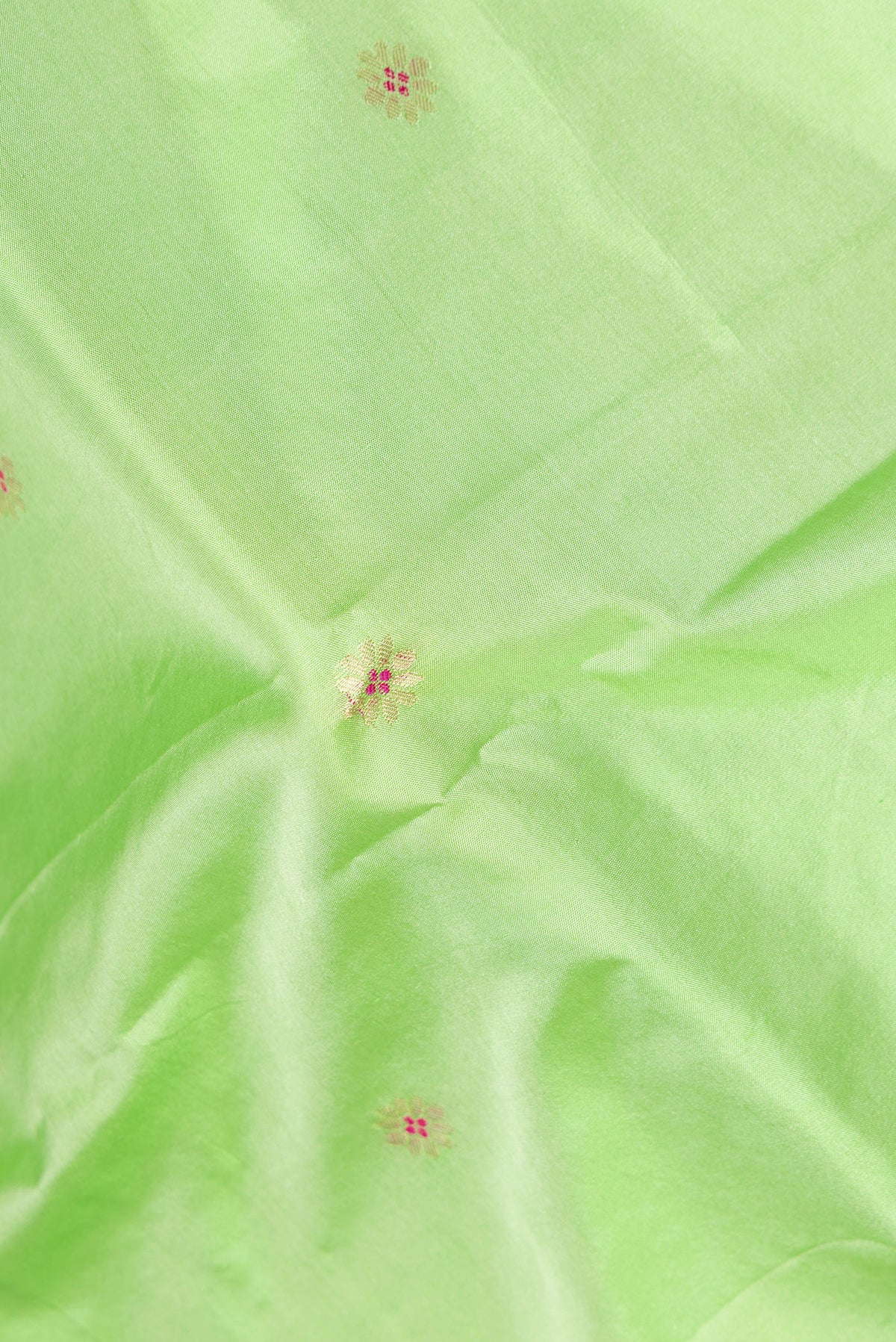 Close up of Pista Green Blended Paithani Silk Saree with Zari Butta on the body and Zari Border.  displaying folds
