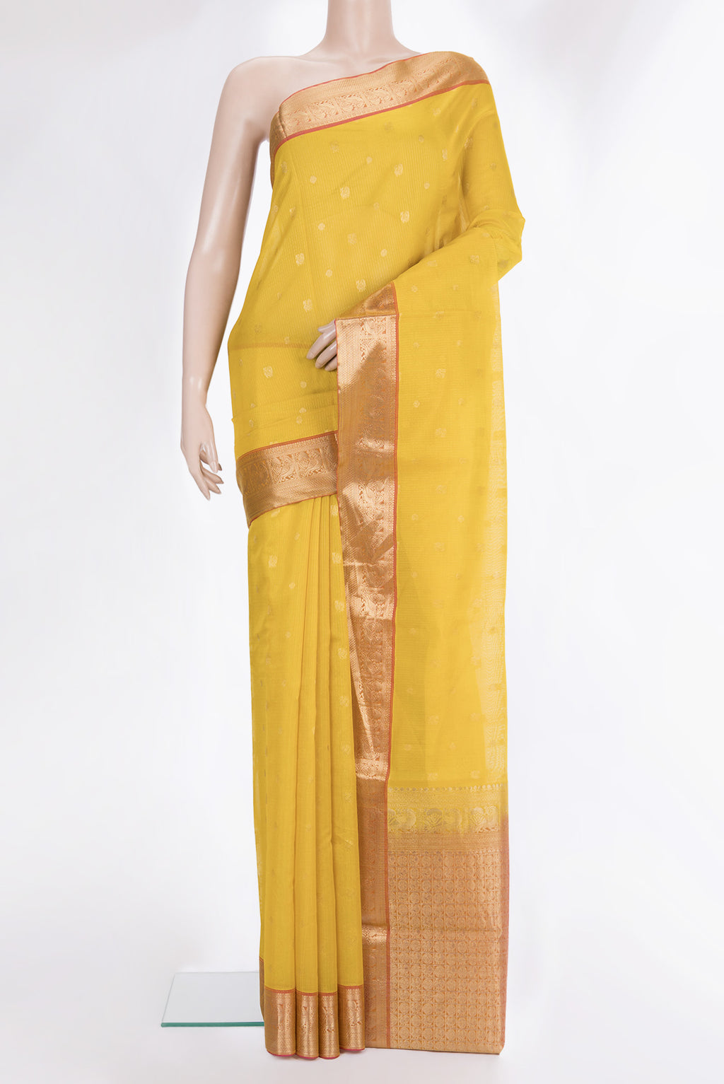 Yellow Silk Cotton Saree with Zari Butta on the body and Zari Border.  displayed on a mannequin