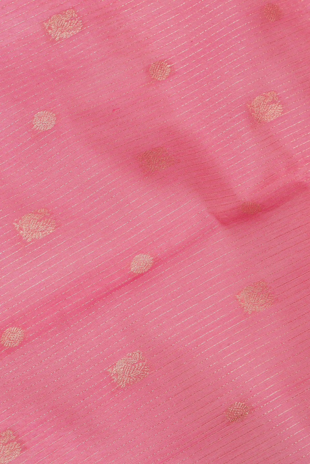 Close up of Coral Silk Cotton Saree with Zari Butta on the body and Zari Border.  displaying folds