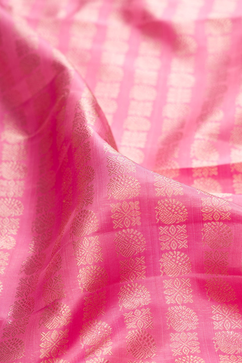 Close up of Pure Silk Pink Kanchipuram Saree with Zari Brocade on the body and Zari Border.  displaying folds